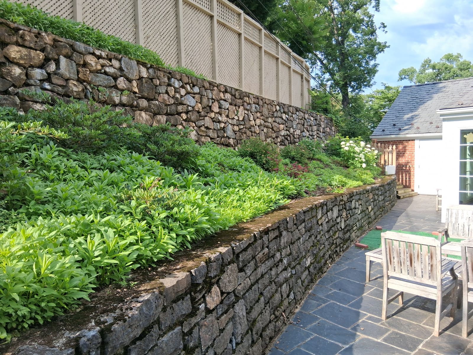 Before — stone wall planting bed before RLD service